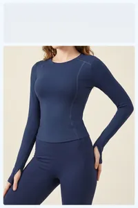 Close-up of slim fit navy blue long-sleeve yoga top with functional thumbhole details