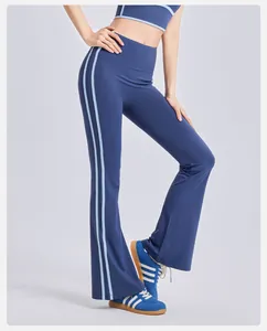 Detail of high-waisted flared yoga pants with side stripes in navy blue.