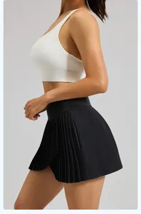 Detailed side view of a black pleated sports skirt with slit and built-in liner.