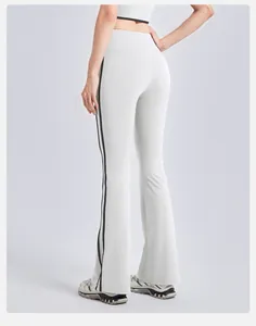 High-waisted white flared yoga pants featuring stylish black side stripes detail
