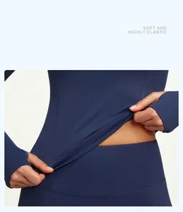 Detail view of highly elastic dark blue yoga top showing soft fabric texture and stretchability