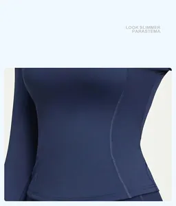 Close-up of curved stitching on slim-fit navy yoga top designed for a slimming effect.