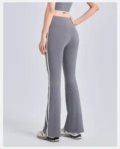 Back view detail of high-waisted flared yoga pants with side stripes and booty lift.