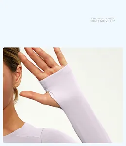 Detail view of women's slim fit yoga top featuring functional thumb holes design for sports