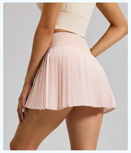 Detail view of a light pink pleated sports skort featuring a slim fitness design.