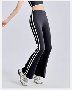 Detail view of black high waisted yoga flare pants with white side stripes and slim fit style
