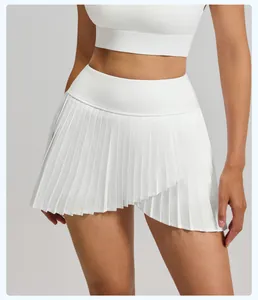 Detail shot of a white pleated tennis skirt with an asymmetric hem and high waist