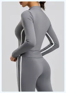 Side view detail of gray long-sleeve yoga jacket with white stripes for fitness wear