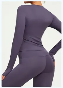 Back view detail of slim-fit purple long-sleeve yoga top with high-elastic fabric