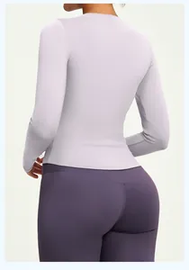 Back view of slim-fit long-sleeve lavender yoga top with dark purple leggings