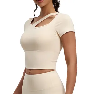 Slim fit yoga short sleeve top with diagonal cutout and built-in pads in minimalist beige.