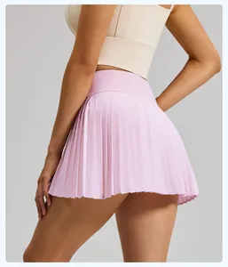 Back view of pink pleated athletic mini skirt with built-in shorts for yoga and fitness