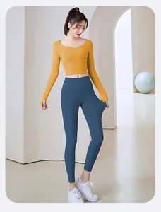 Detailed view of yellow long-sleeve yoga crop top and blue high-waist leggings set