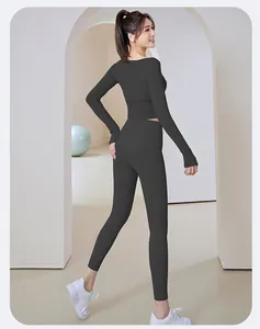 Slim fit black long sleeve yoga set featuring high waist leggings on an Asian model