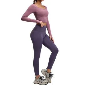 Women's two-piece yoga workout set with built-in bra, mauve top and purple leggings