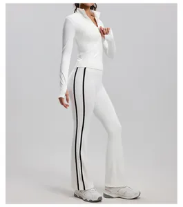 Detail of white yoga set featuring black side stripes and slim fit long-sleeved jacket.