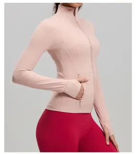 Detail view of pink slim-fit sports jacket with thumbholes and stitching for yoga