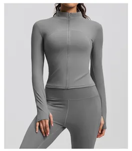 Detail view of a gray ribbed athletic jacket featuring a stand collar and thumb holes.