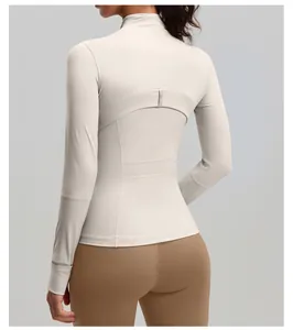 Slim fit beige athletic yoga jacket featuring a panelled back design and stand collar.