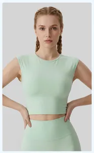 Close-up of light green mint sleeveless sports crop top on female model