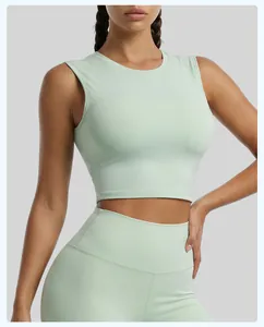 Front view detail of a mint green sleeveless cropped sports top for yoga and fitness training.
