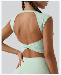 Close-up view of light green sports bra showing an open back with stylish twist knot.