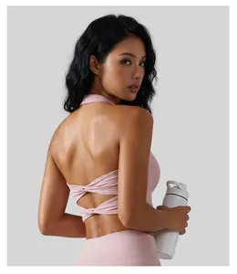 Detailed back view of pink twist halter yoga sports bra with cross-strap design