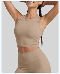 Close-up view of tan sleeveless athletic sports tank top worn by a female fitness model