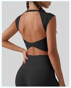 Detailed view of a black sports bra with a stylish cutout and twist back design.