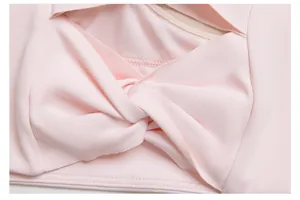 Close-up detail of twisted front design on pink high-elasticity yoga sports bra.