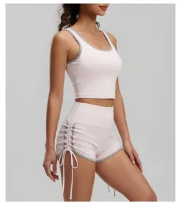 Vista laterale dei pantaloncini sportivi rosa a vita alta con coulisse e bordo grigio