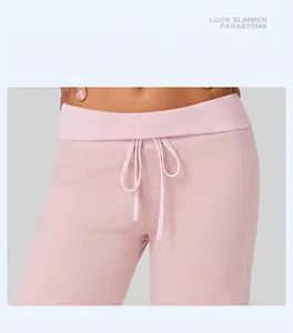 Close-up of pink yoga pants featuring a contrast drawstring waistband and soft fabric