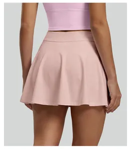 Back view of high-waisted pleated pink tennis skirt for women's athletic sports wear