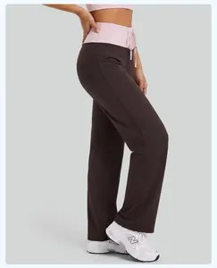 Detail view of high-waisted contrast yoga pants with drawstring waistband in brown