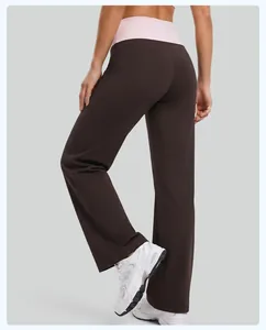 Close-up detail of brown wide-leg yoga pants featuring a pink fold-over high waistband