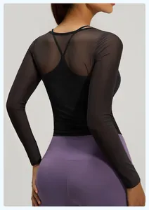 Rear view detail of black mesh long-sleeve yoga top with breathable back design