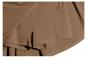 Close-up of brown athletic skort showing built-in shorts, side pocket, and fabric texture
