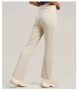Back view detail of professional high-waisted wide-leg yoga pants in cream beige color