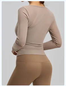 Detailed back view of a breathable mesh long sleeve yoga shrug top in taupe color