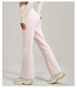 Detailed back view of light pink high-waisted flare yoga pants featuring a functional rear pocket