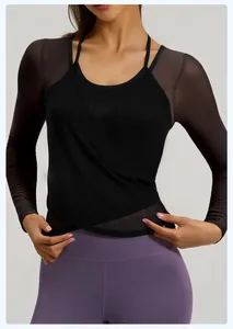 Detail of black mesh yoga top with cross-wrap design and breathable long sleeves.