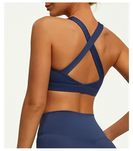 Close-up detail of navy blue cross-back yoga sports bra with nude-feel fabric texture