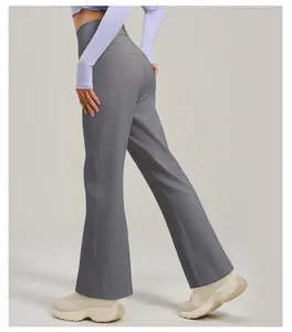 Detailed side view of high-waist flared yoga pants in a gray moisture-wicking fabric