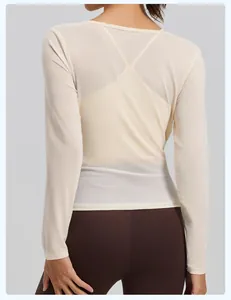 Detailed back view of a breathable mesh long sleeve yoga cover-up top in beige