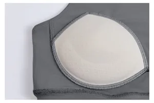 Detail of breathable inner chest pad on grey sports bra for fitness and yoga.