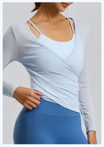 Detailed view of a light blue mesh wrap yoga top featuring breathable fabric texture