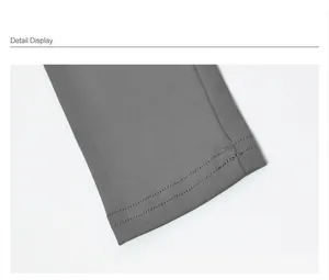 Close-up of the professional double stitching on a grey slim-fit yoga top sleeve detail.