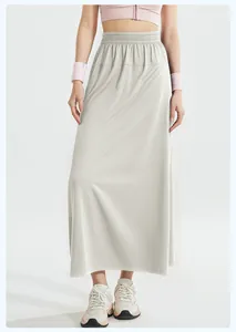 Detail view of loose A-line sports skirt-pants with elastic high waist in light grey.