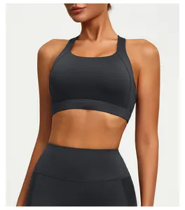 Close-up of a charcoal grey cross-back yoga sports bra and high-waist leggings on model