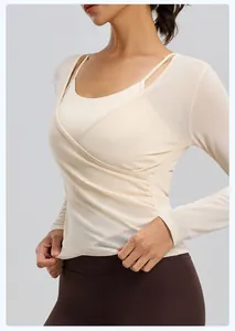 Detailed view of the breathable cream mesh long sleeve yoga top with layered sports bra